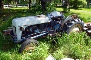 Ford tractor sitting in the grass