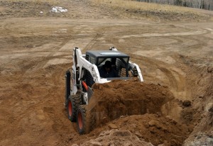 Bobcat moved material up to corner pad.