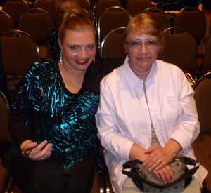 Felicity in makeup sits with  Pam.