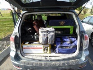 Car packed up for trip. Grey case is a cooler.