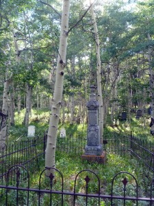 Grave sites are scattered beneath the aspen.