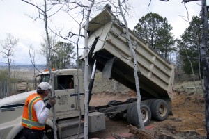 First truck starts dumping at the top of the circular drive