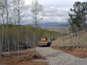 Two guys and my shed components on a trailer arrive at the top of the drive. Note how much gravel I have spread